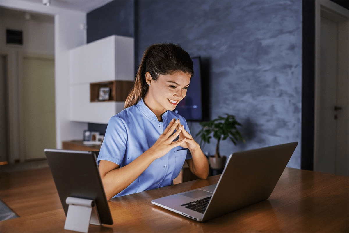 a woman sitting in front of a laptop computer