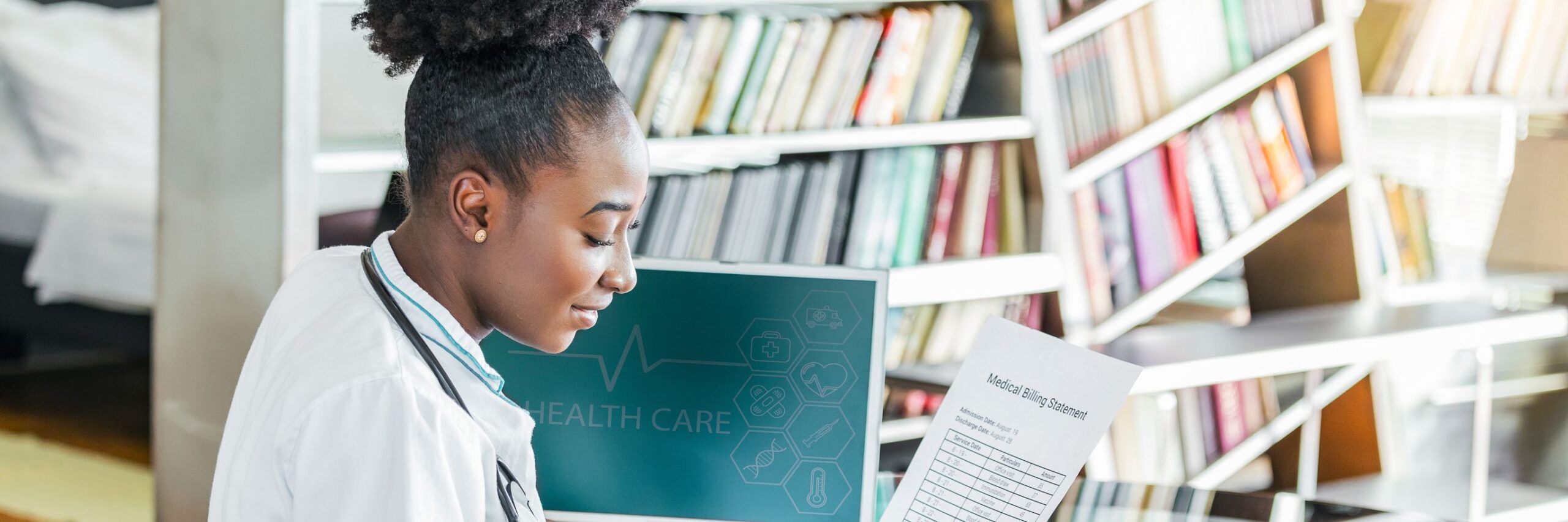 A female medical professional reviews a medical report next to a computer displaying healthcare graphics, in a library with shelves of books in the background.